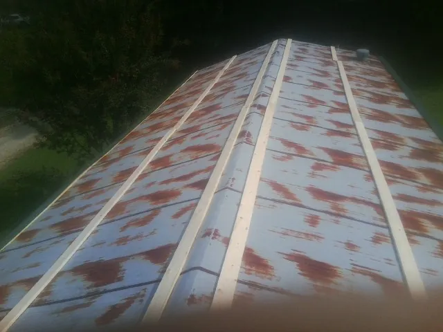 Rusted metal roof panels with new wood purlins before replacement — Storm Damage Roof Repair in Ona by Roofing Brothers